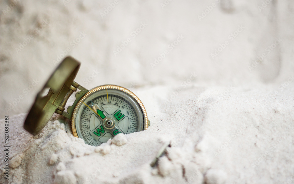 compass on the sea sand and place for text compass on the sea sand and place for text