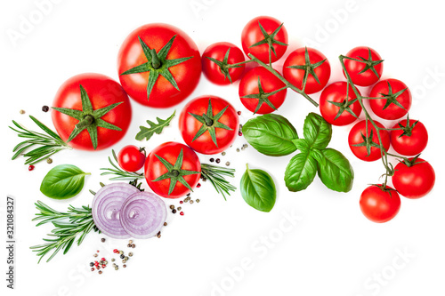 Creative layout made of Tomato, herbs and spices. Red tomatoes, onion, pepper and basil leaves isolated on white background. Flat lay. Top view