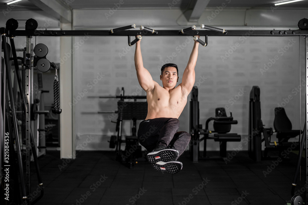 Fototapeta premium Muscular fitness man bodybuilder is workout in gym