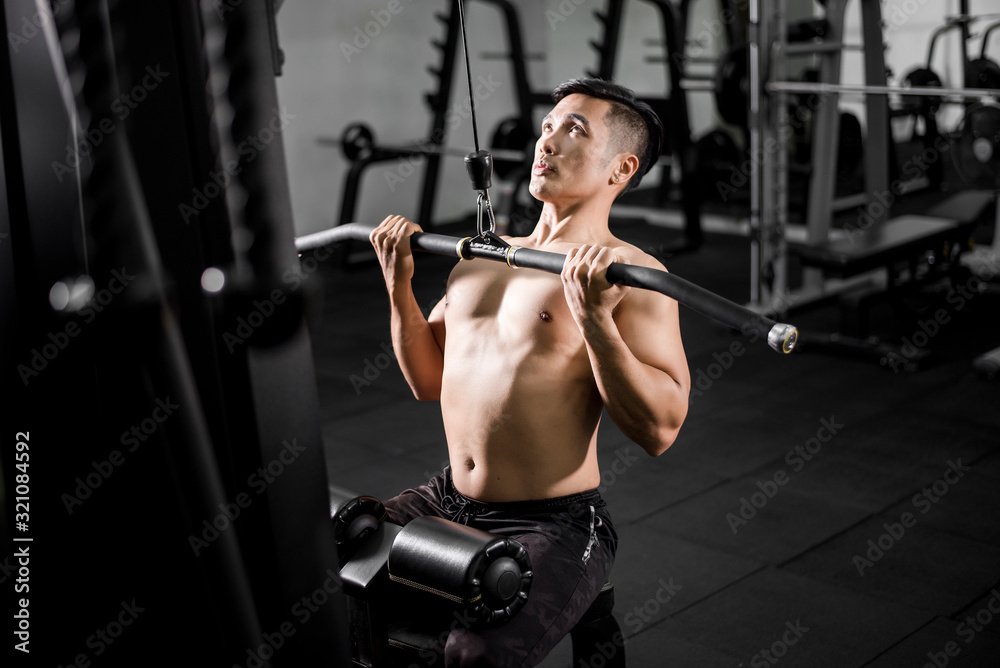 Muscular fitness man bodybuilder is workout in gym Muscular fitness man bodybuilder is workout in gym