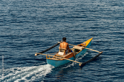 Philippine fisher on banca boat in the morning on island cebu