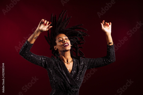 Canvas-taulu Woman with dreadlocks wearing a sparkly dress in celebrating, happy, fun