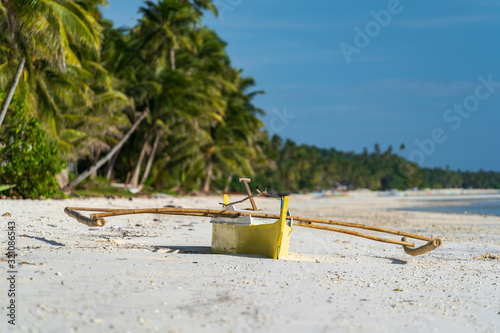 Banca boat on philippine white beach on island siquijor. paliton Beach coral cay evening