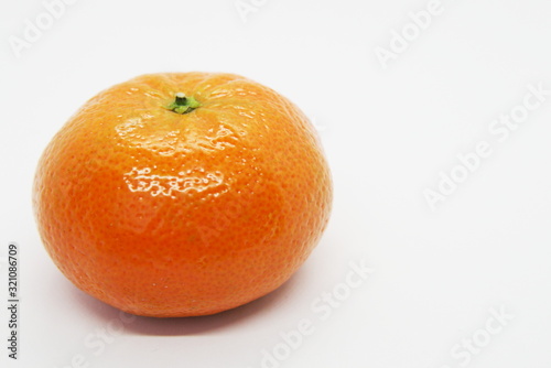 juicy  ripe and fresh tangerine on a light background