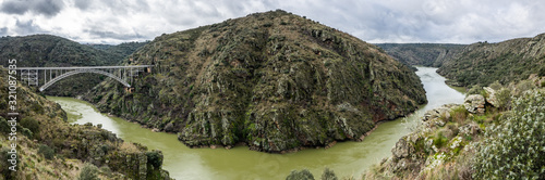 Panoramic photography of the area known as the Arribes del Duero in Zamora, Spain. The metal arch bridge known as Puente Requejo is seen photo