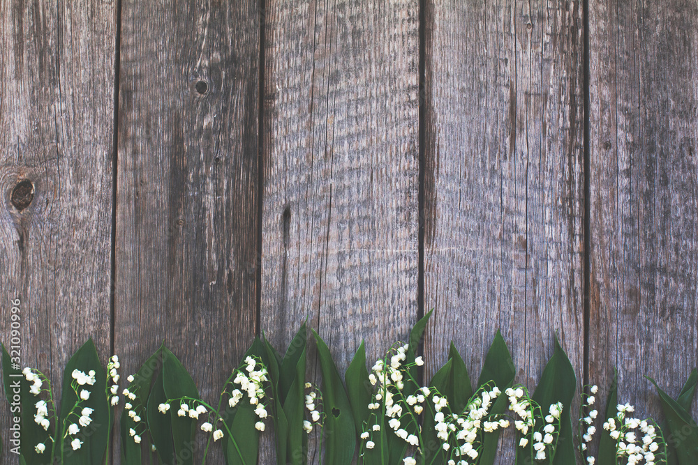 lily of the valley on rustic wooden background. spring background/ easter background lily of the valley on rustic wooden background. spring background/ easter background