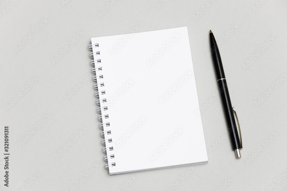 Blank notebook or notepad with pencil on gray desk background Blank notebook or notepad with pencil on gray desk background