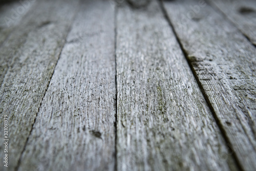 Wall of old wooden boards in natural color. Selective focus.