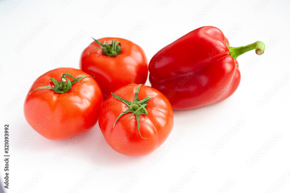 Vegetables sweet pepper and tomatoes on a white background Vegetables sweet pepper and tomatoes on a white background