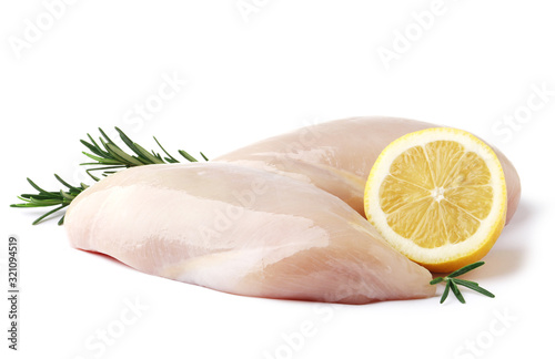 raw chicken filet with lemon and rosemary isolated on a white background