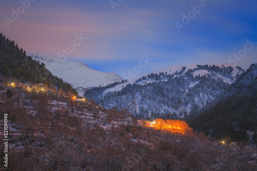 Winter evening on Agrafa mountains where the fresh snow has covered the scenery that is illuminated by the moon light
