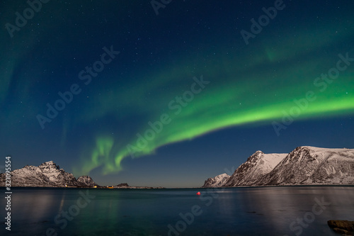 amazing northern lights, aurora borealis over the mountains in the North of Europe - Lofoten islands, Norway © Tatiana