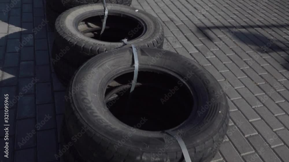 Kart racing track, road surface. Safety Guard, fence made of old tires. place for text. Go karts racing, rent. extreme sport. fun entertainment for drivers, Slow motion. Kart racing track, road surface. Safety Guard, fence made of old tires. place for text. Go karts racing, rent. extreme sport. fun entertainment for drivers, Slow motion.