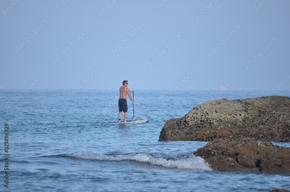 man surfing stand up in the sea