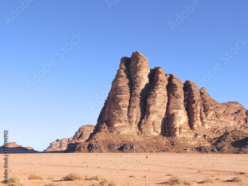 The "Seven Pillars of Wisdom" rock formation in Wadi Rum desert in Jordan. Clear blue sky. Beautiful landscape.