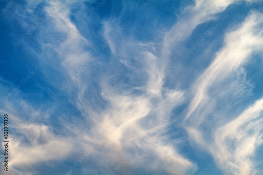 blue sky with white feather clouds