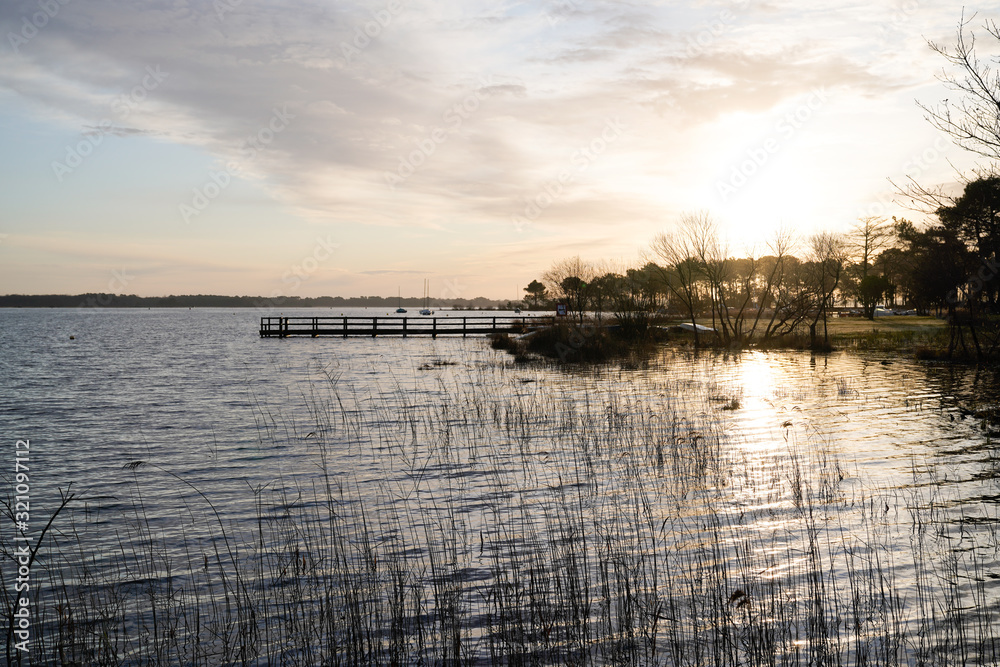 Fototapeta premium Biscarrosse lake at sunset with boat pontoon in france