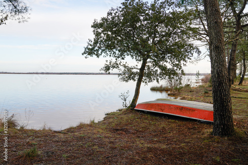 winter Lake small boat in sand beach in Biscarrosse Landes 40 France