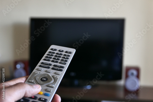 Closeup of man hand using Tv remote 