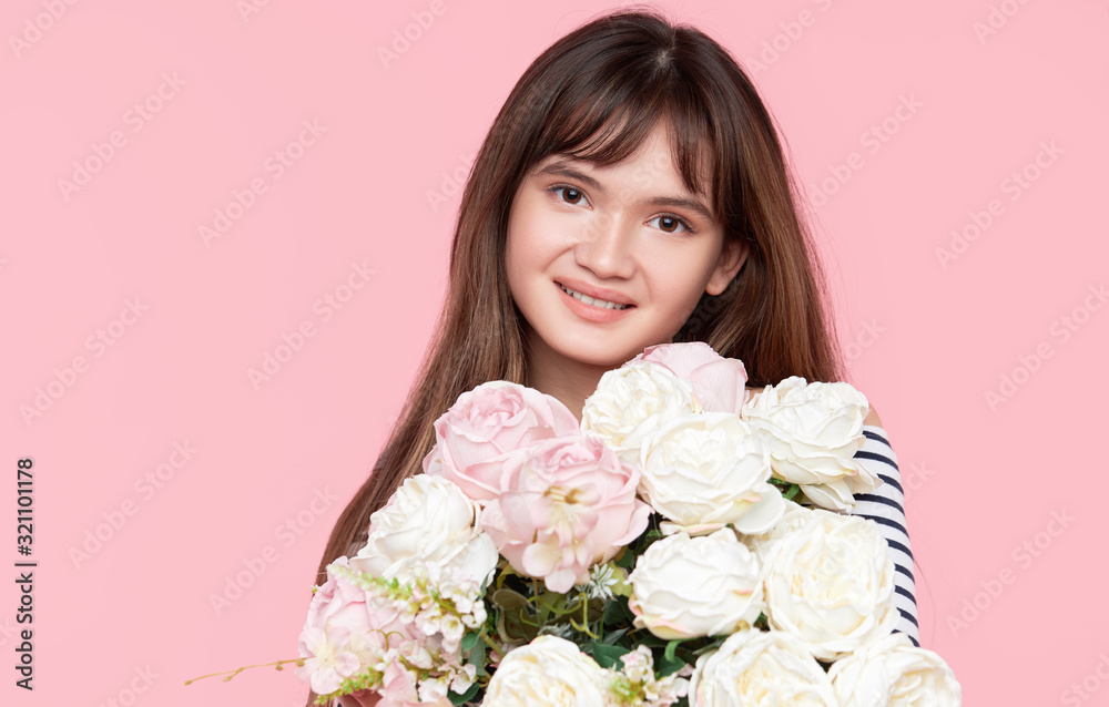 Beautiful Asian girl holds a beautiful lush bouquet in her hands on a light background Beautiful Asian girl holds a beautiful lush bouquet in her hands on a light background