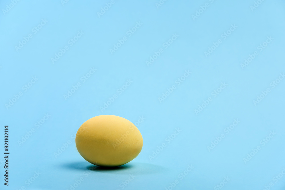 Yellow chicken egg on a blue background. Yellow chicken egg on a blue background.