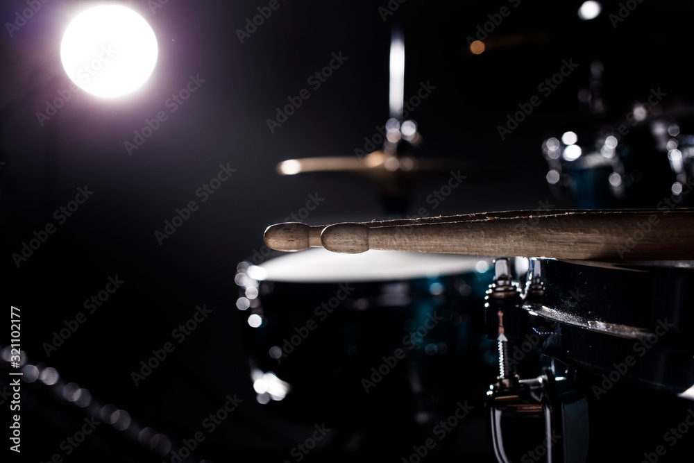 Obraz premium Musical instruments drum kit, flash of light, a beautiful light in the background with copy space