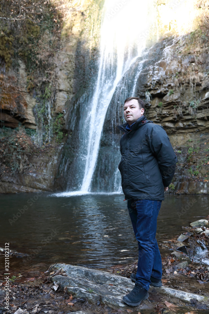 Fototapeta premium Man and waterfall