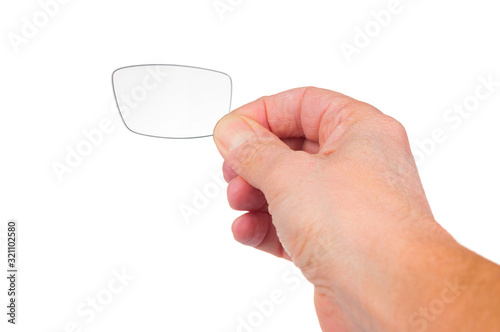 Man`s hand holding eyeglasses lens on white background