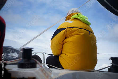 White bearded sailing senior, experienced skipper on a sailboat