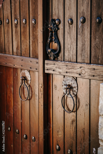 Old brown wooden gate with rings, closeup.