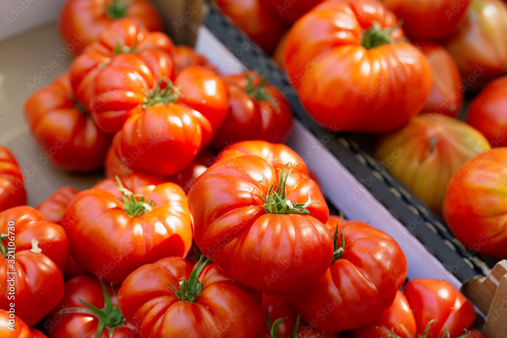 fresh tomatoes in a box on a market