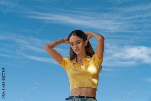 Teenage girl in yellow top and arms up © Brian Scantlebury