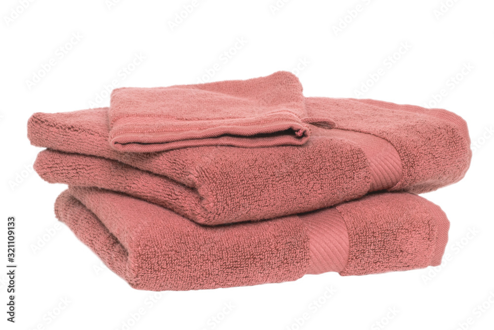 Towels isolated. Closeup of a stack or pile of old pink soft terry bath towels isolated on a white background. Towels isolated. Closeup of a stack or pile of old pink soft terry bath towels isolated on a white background.