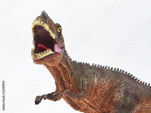 Tyrannosaur rubber toy isolated on white photo