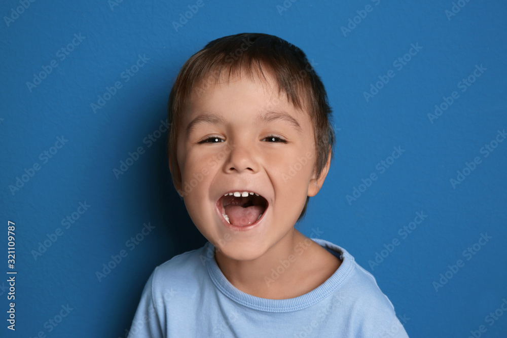 Portrait of excited little boy on blue background Portrait of excited little boy on blue background