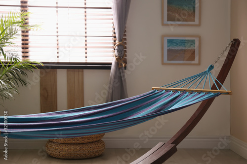 Comfortable blue hammock in stylish room. Interior design