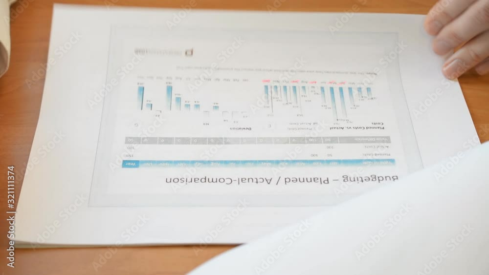close-up of financial statements and trading charts in financial markets male hands check errors close-up of financial statements and trading charts in financial markets male hands check errors