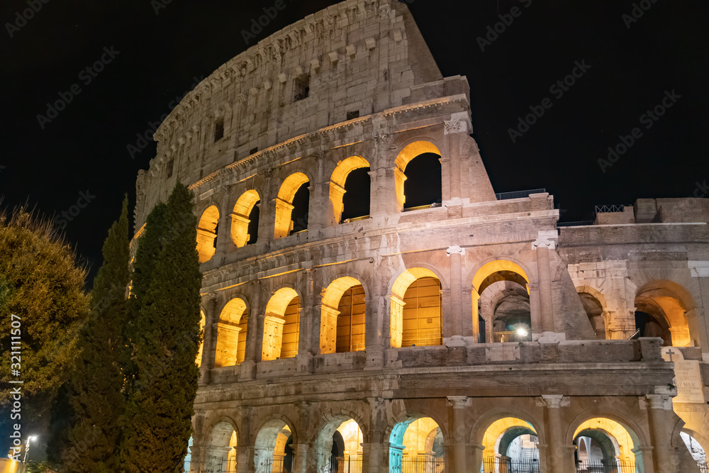 Colosseum or Coliseum at night, Rome, Italy. Ancient Roman Colloseum. Illuminated at night