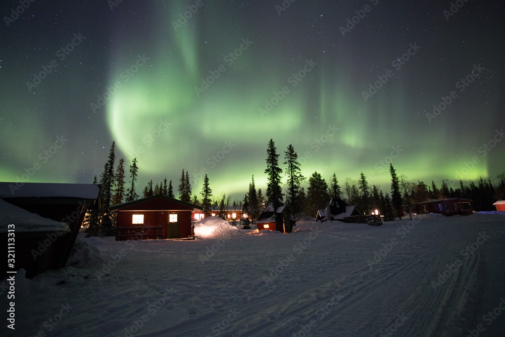 Northern Lights dancing over the sky at camp Alta, Kiruna, Lapland, Sweden. The most amazing phenomena on earth.