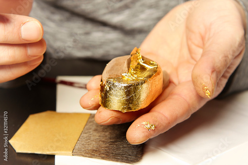 Artwork of gilding - covering an object with plate metal gold
