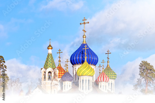 orthodox church in moscow city at winter time russian christianity religion architecture landmark against blue clouds sky background. Street side view of colorful domes of cathedral. Scenic landscape