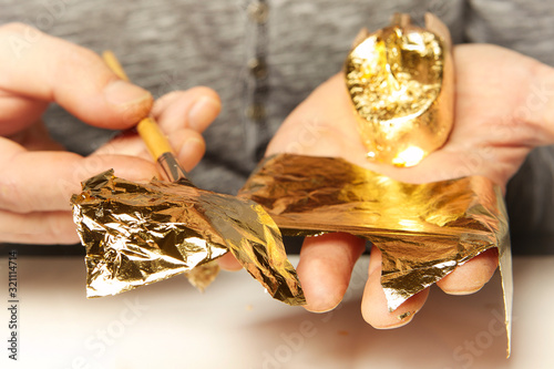 Artwork of gilding - covering an object with plate metal gold