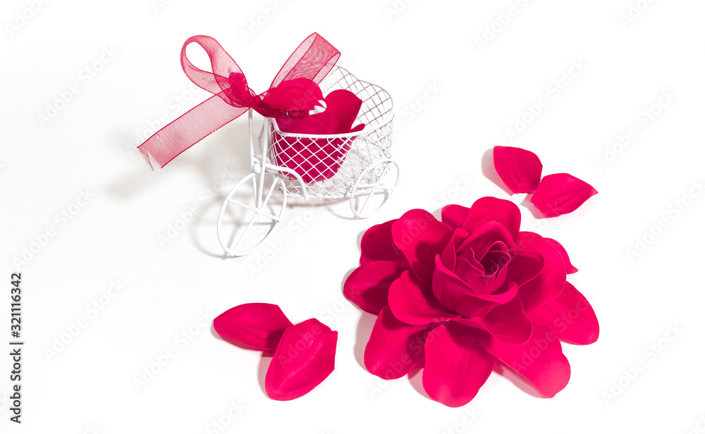 Purple rose and miniature Bicycle decorated with roses on a white background. Purple rose and miniature Bicycle decorated with roses on a white background.
