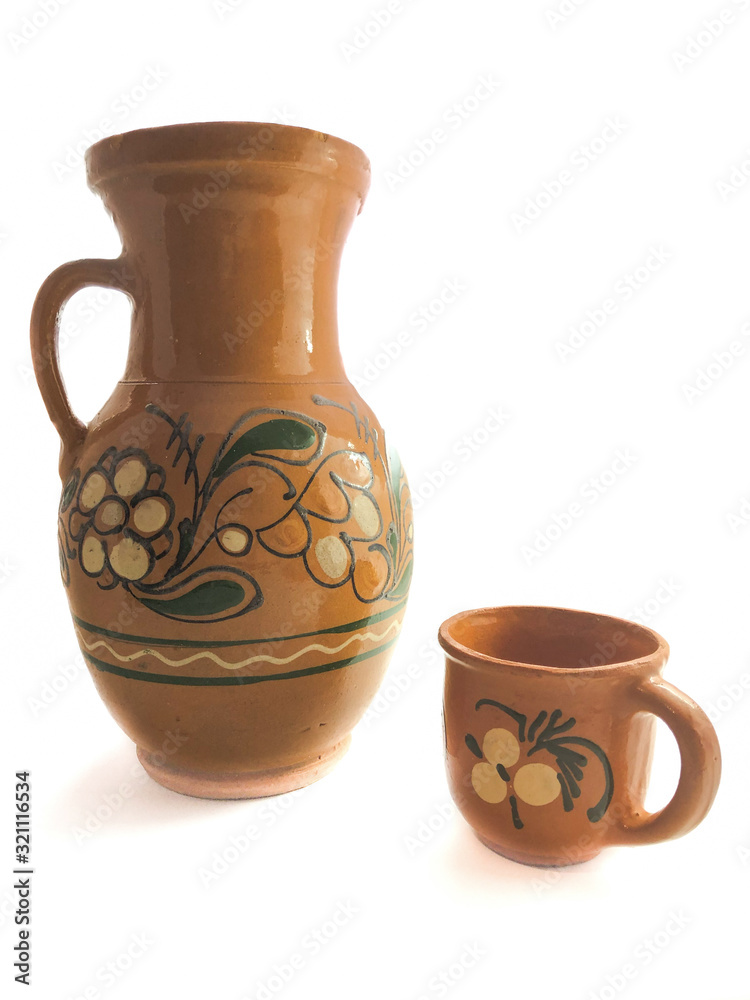 Clay jug and cup isolated on a white background.