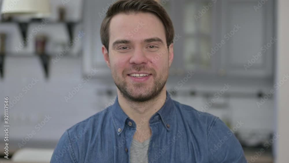 Portrait of Beard Young Man showing Victory Sign 