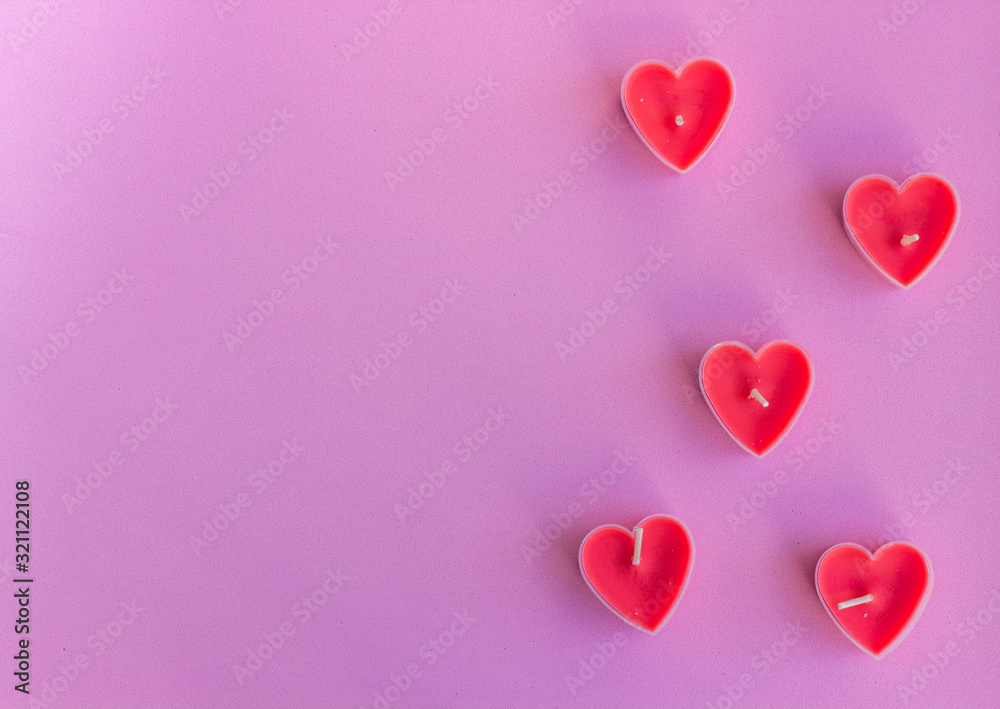 Hearts on the pink background. Candles in the shape of hearts. Happy Valentines Day. 14 February, women's day, March 8. Top view. Flat lay. Greeting card. Copy space for text.