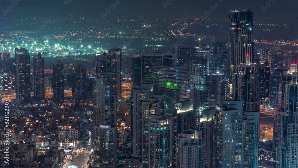 Amazing aerial view of Dubai downtown skyscrapers night timelapse with fountains, Dubai, United Arab Emirates. Illuminated modern towers and construction site Amazing aerial view of Dubai downtown skyscrapers night timelapse with fountains, Dubai, United Arab Emirates. Illuminated modern towers and construction site