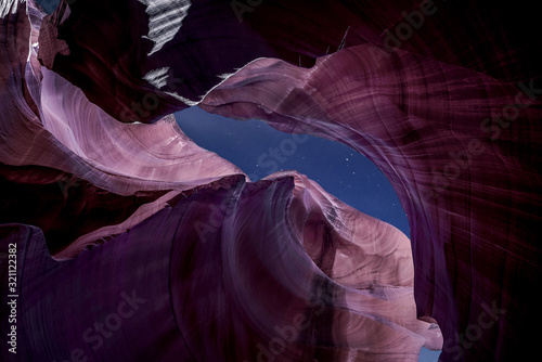 Antelope Canyon's red rock formations under a midnight blue evening sky in Page, Arizona, USA.	