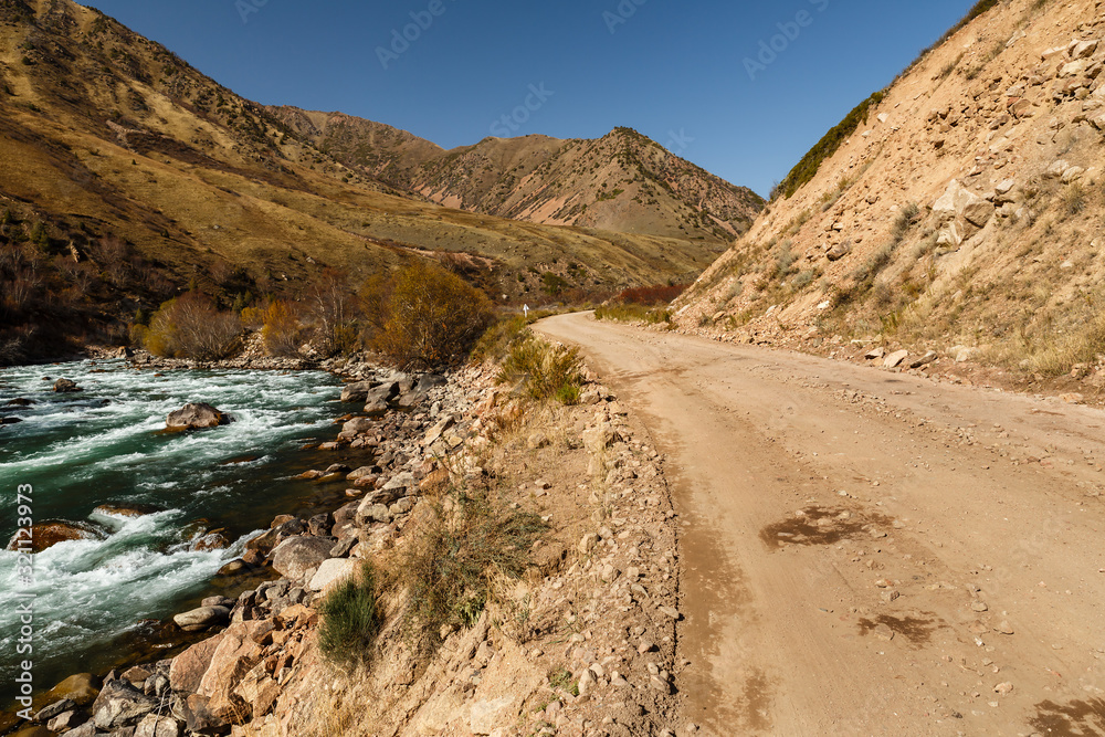 mountain road along the fast river, Kokemeren river, Kyzyl-Oi, Jumgal District, Kyrgyzstan