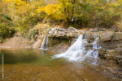 Fototapeta Naklejka Na Ścianę i Meble -  A small Mountain waterfall in autumn in Gelendzhik. Waterfalls on the Jean river